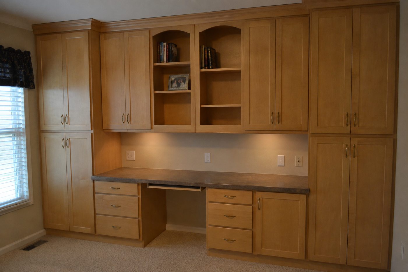 Built-in maple cabinetry and desk before removal